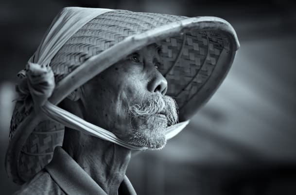elderly man in a bamboo cap